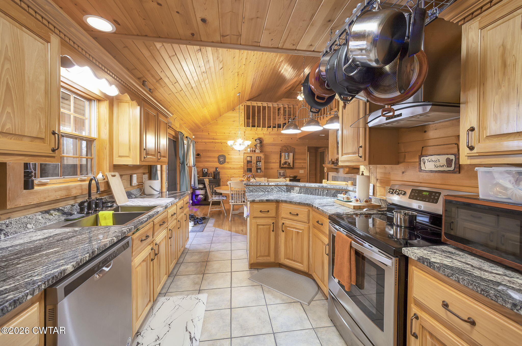372 Aubrey Fergerson Road Gadsden, TN 38337 - Photo 14 of 50 a kitchen with stainless steel appliances granite countertop a sink a stove and a wooden floors