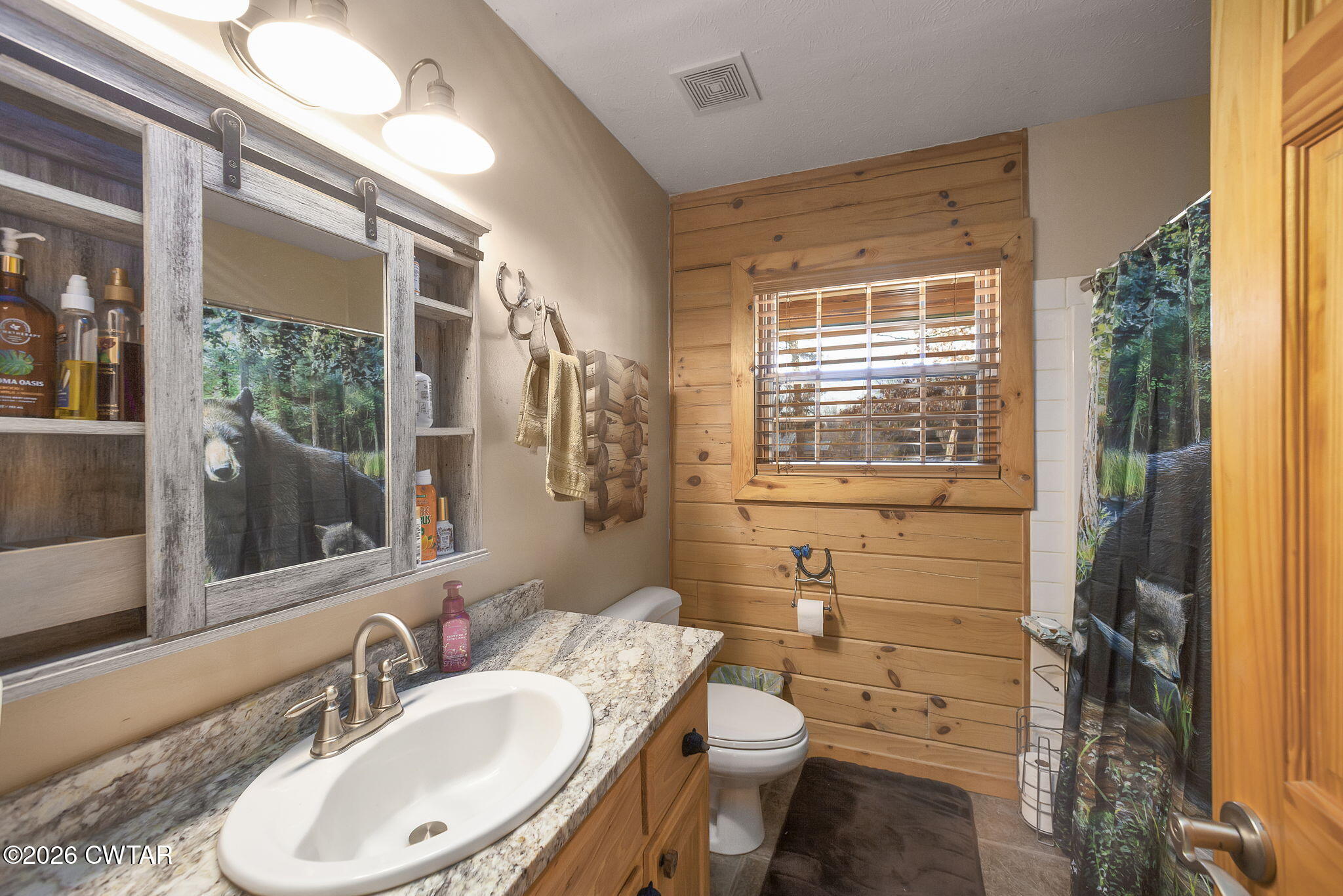 372 Aubrey Fergerson Road Gadsden, TN 38337 - Photo 23 of 50 a bathroom with a granite countertop toilet a sink and a mirror