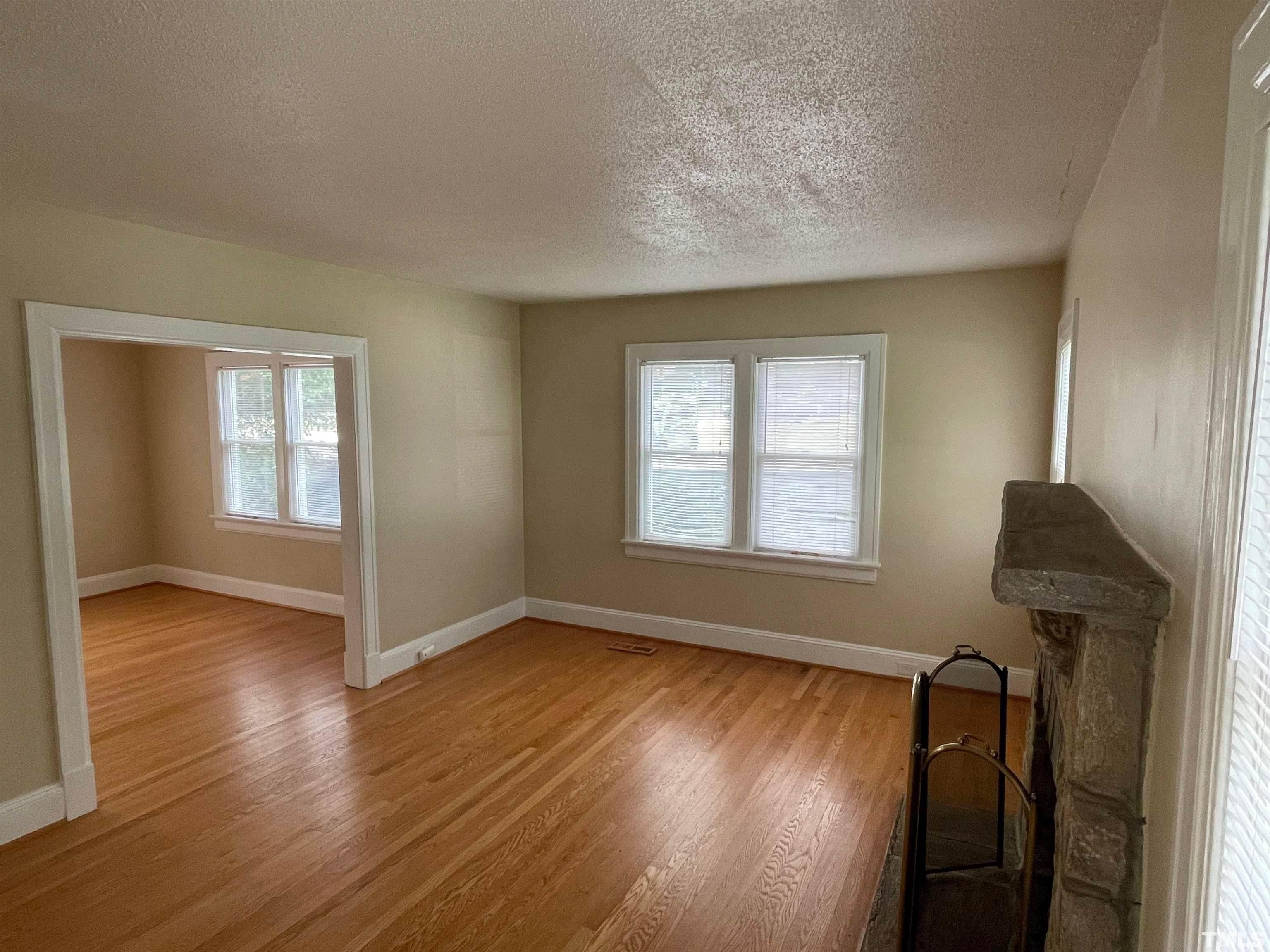 110 Shepherd Street Raleigh, NC 27607 - Photo 2 of 23 a view of an empty room with wooden floor and a window