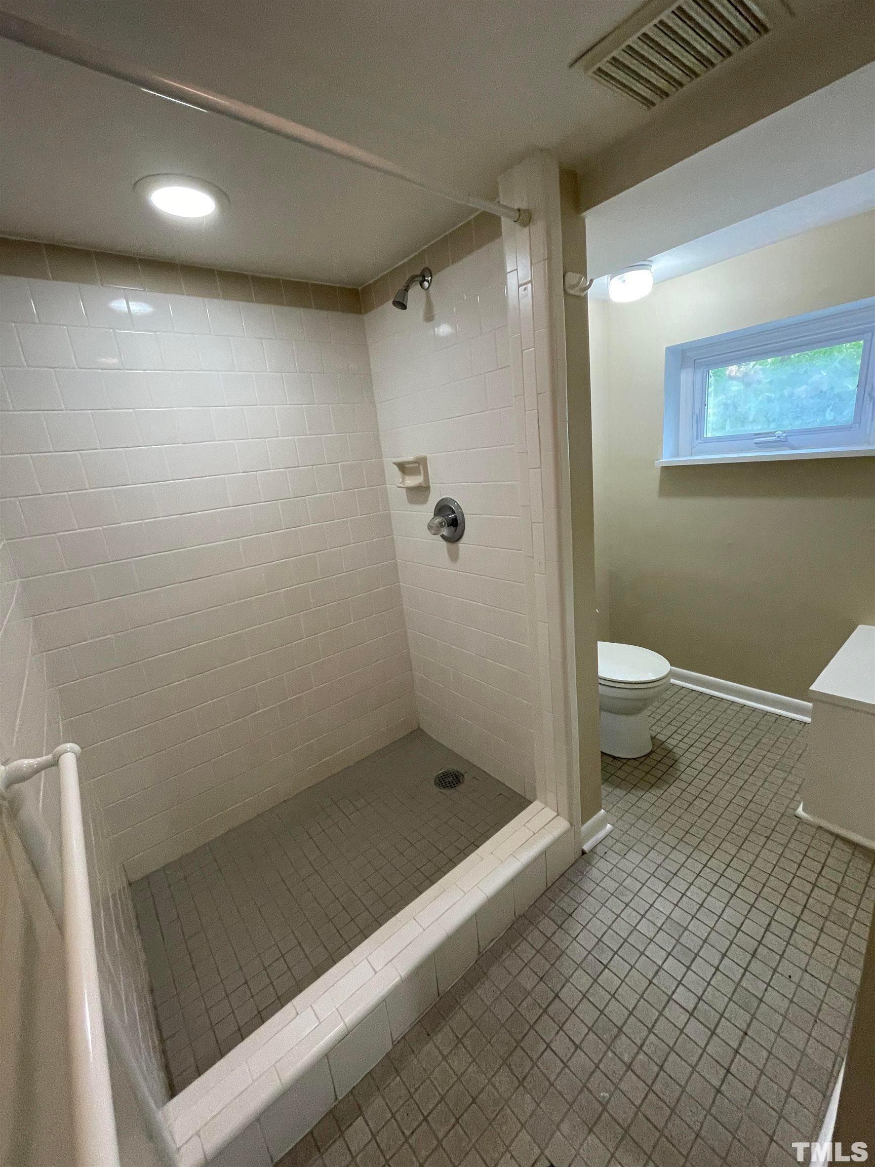 110 Shepherd Street Raleigh, NC 27607 - Photo 21 of 23 a bathroom with a shower and a toilet