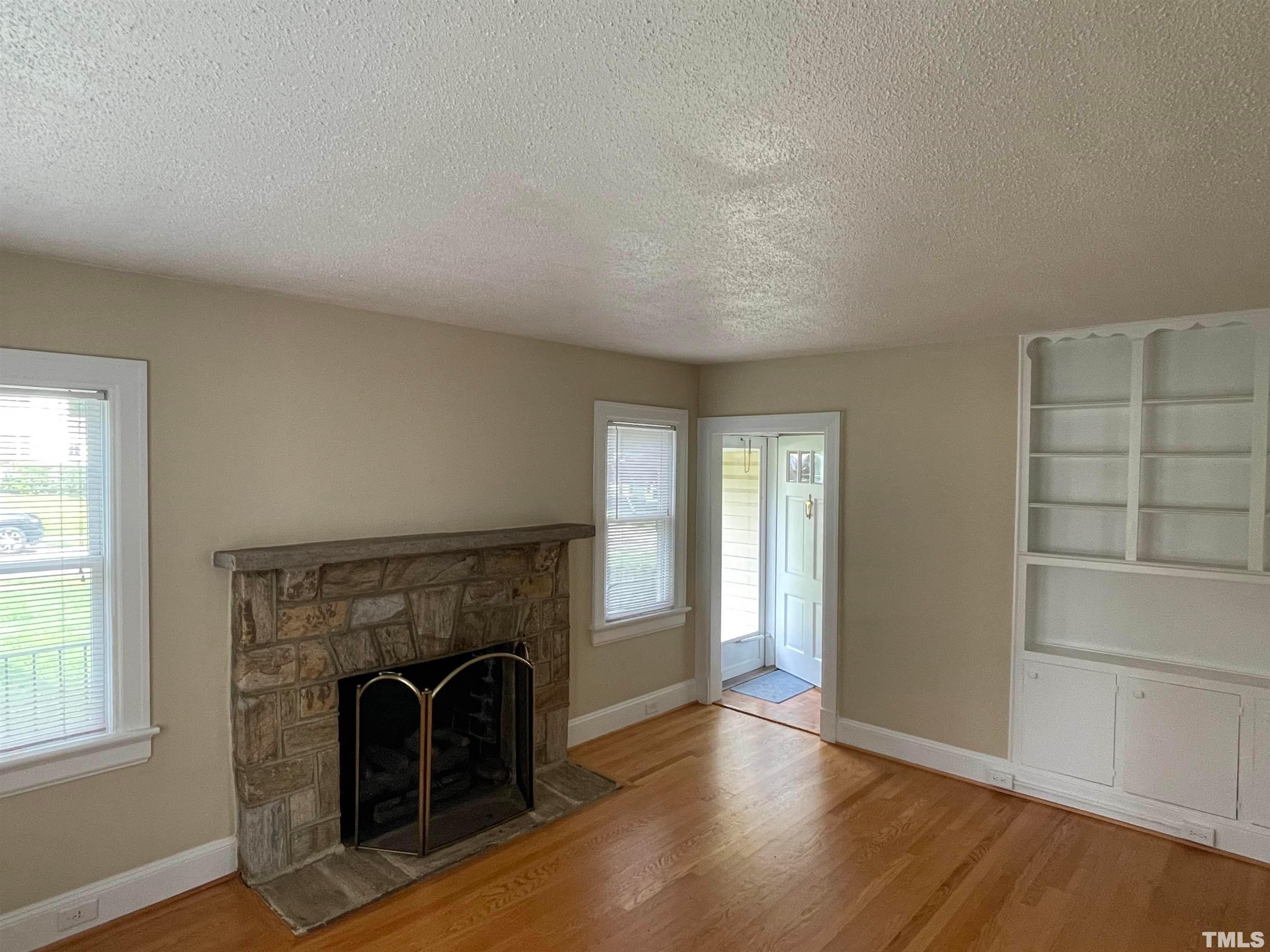 110 Shepherd Street Raleigh, NC 27607 - Photo 3 of 23 an empty room with windows and fireplace