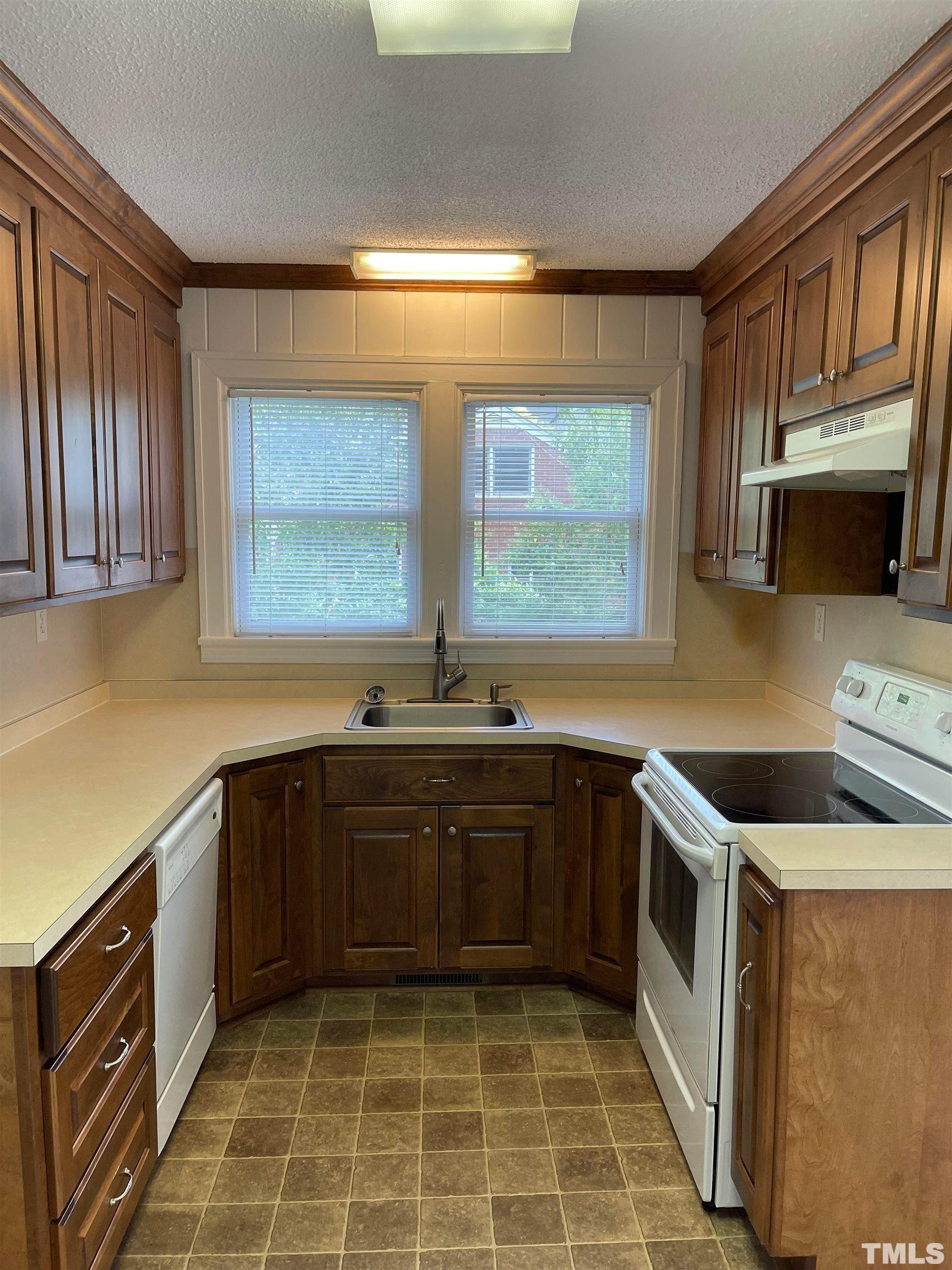 110 Shepherd Street Raleigh, NC 27607 - Photo 8 of 23 a kitchen with a sink stove top oven and cabinets
