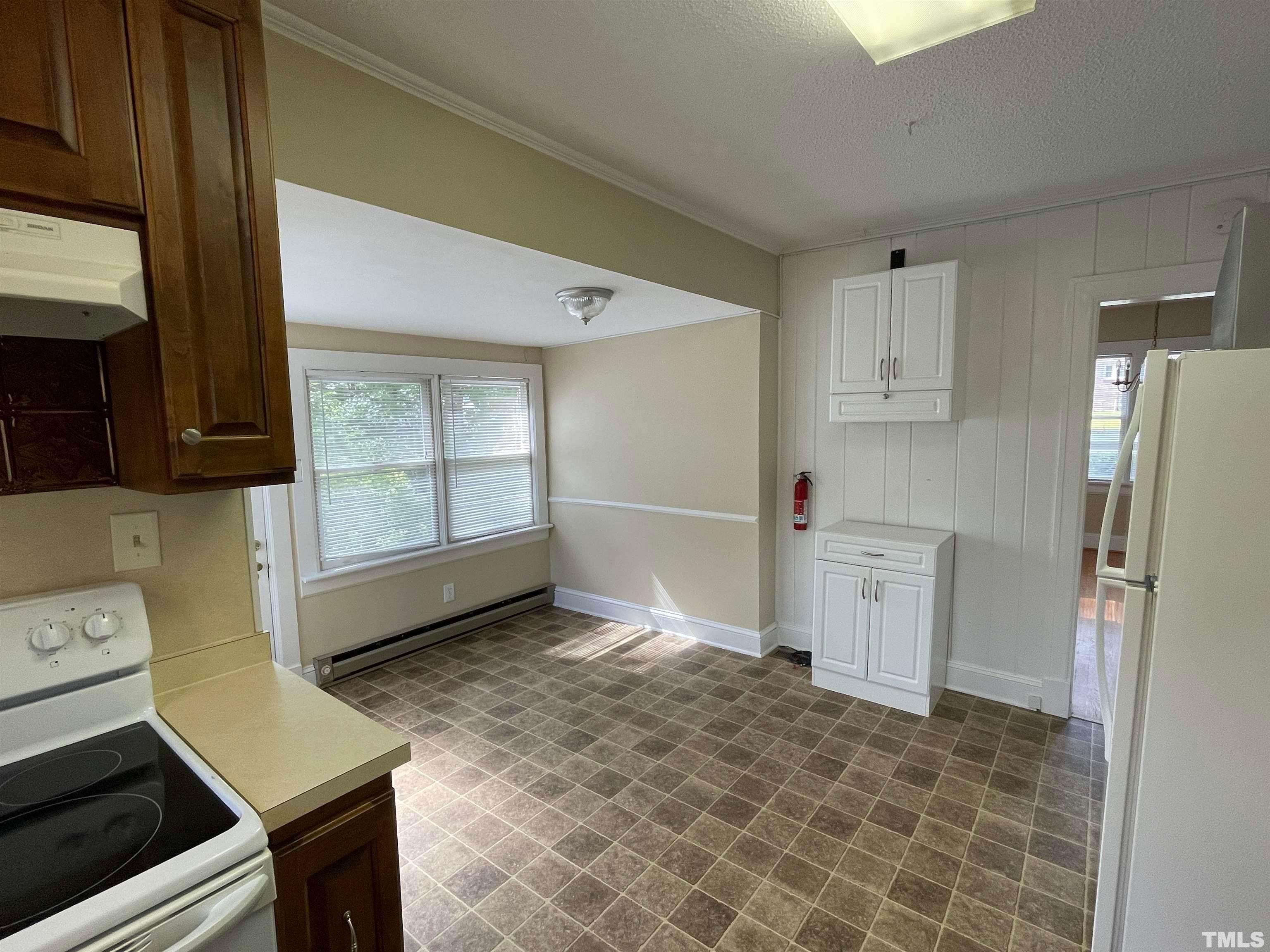 110 Shepherd Street Raleigh, NC 27607 - Photo 9 of 23 a kitchen with granite countertop a refrigerator sink stove and cabinets