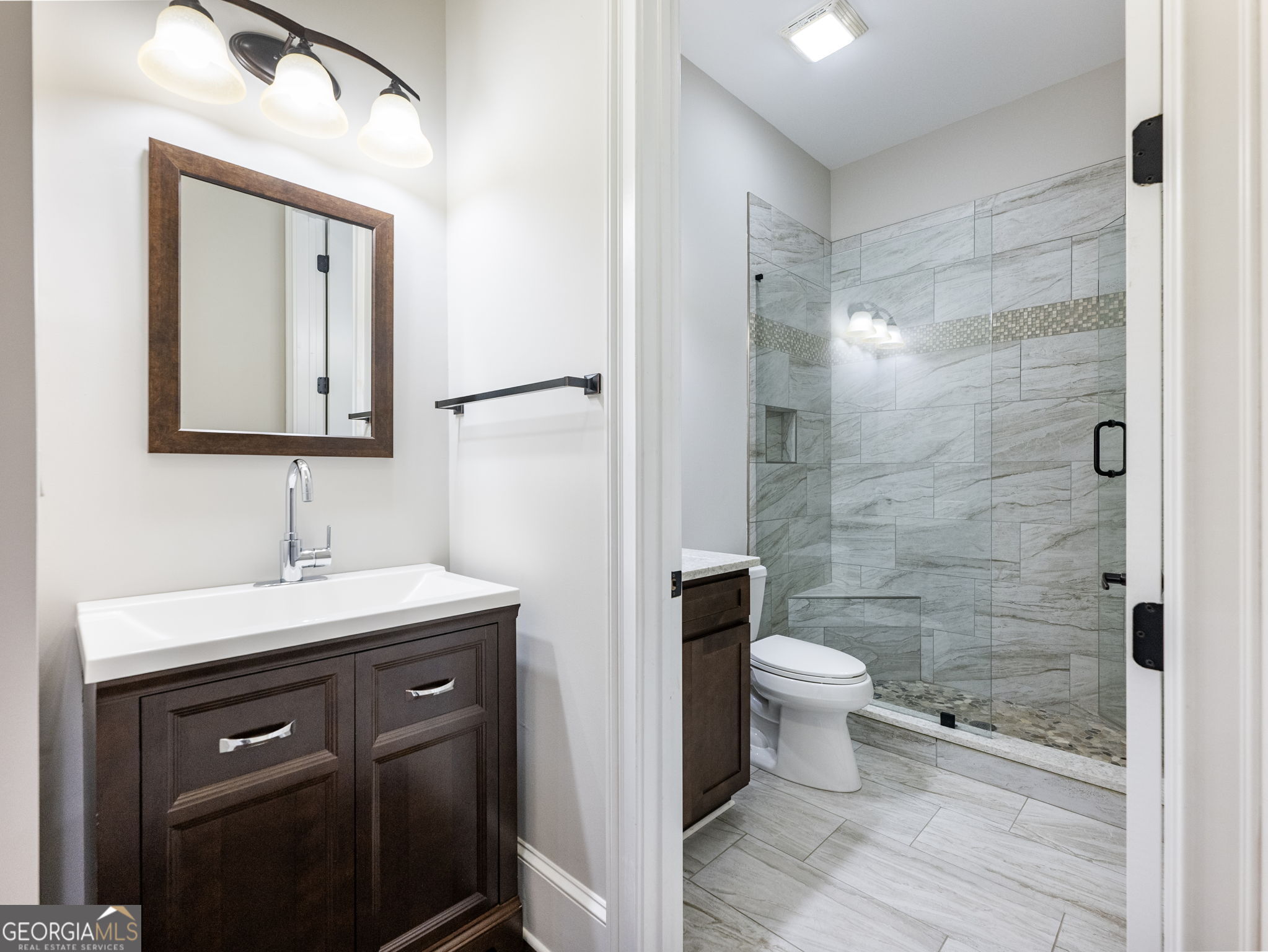125 Iron Horse Trail Lula, GA 30554 - Photo 24 of 86 a bathroom with a toilet sink and a mirror