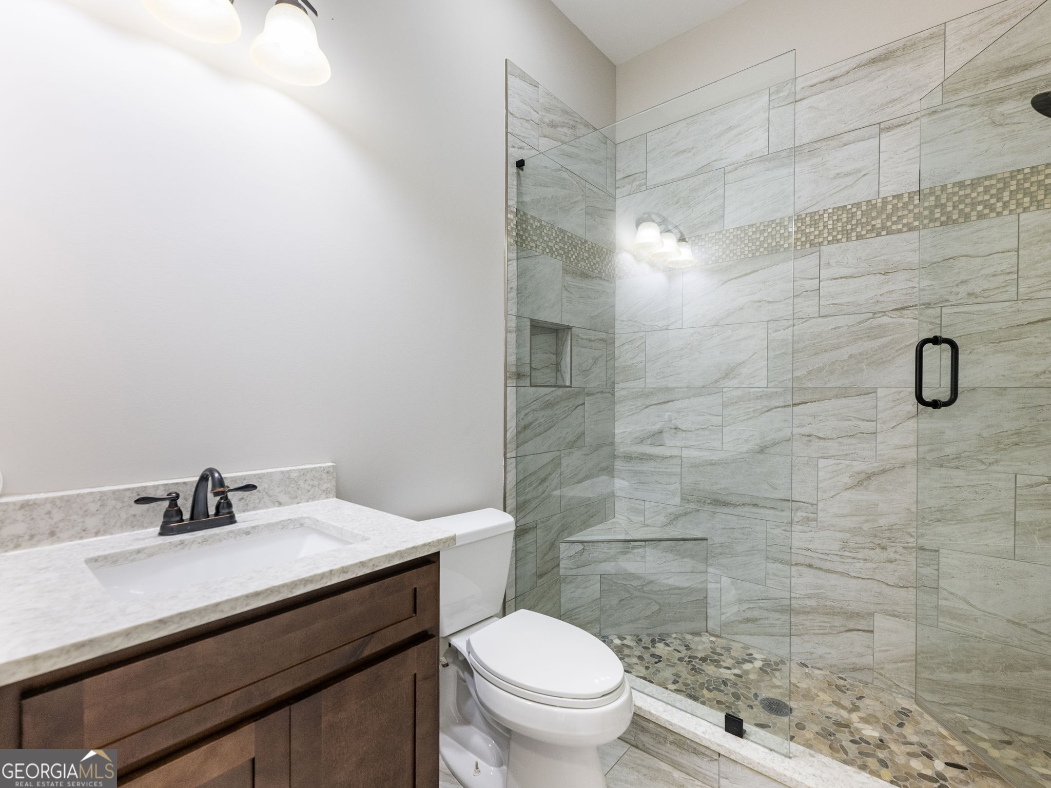 125 Iron Horse Trail Lula, GA 30554 - Photo 25 of 86 a bathroom with a sink a toilet and shower