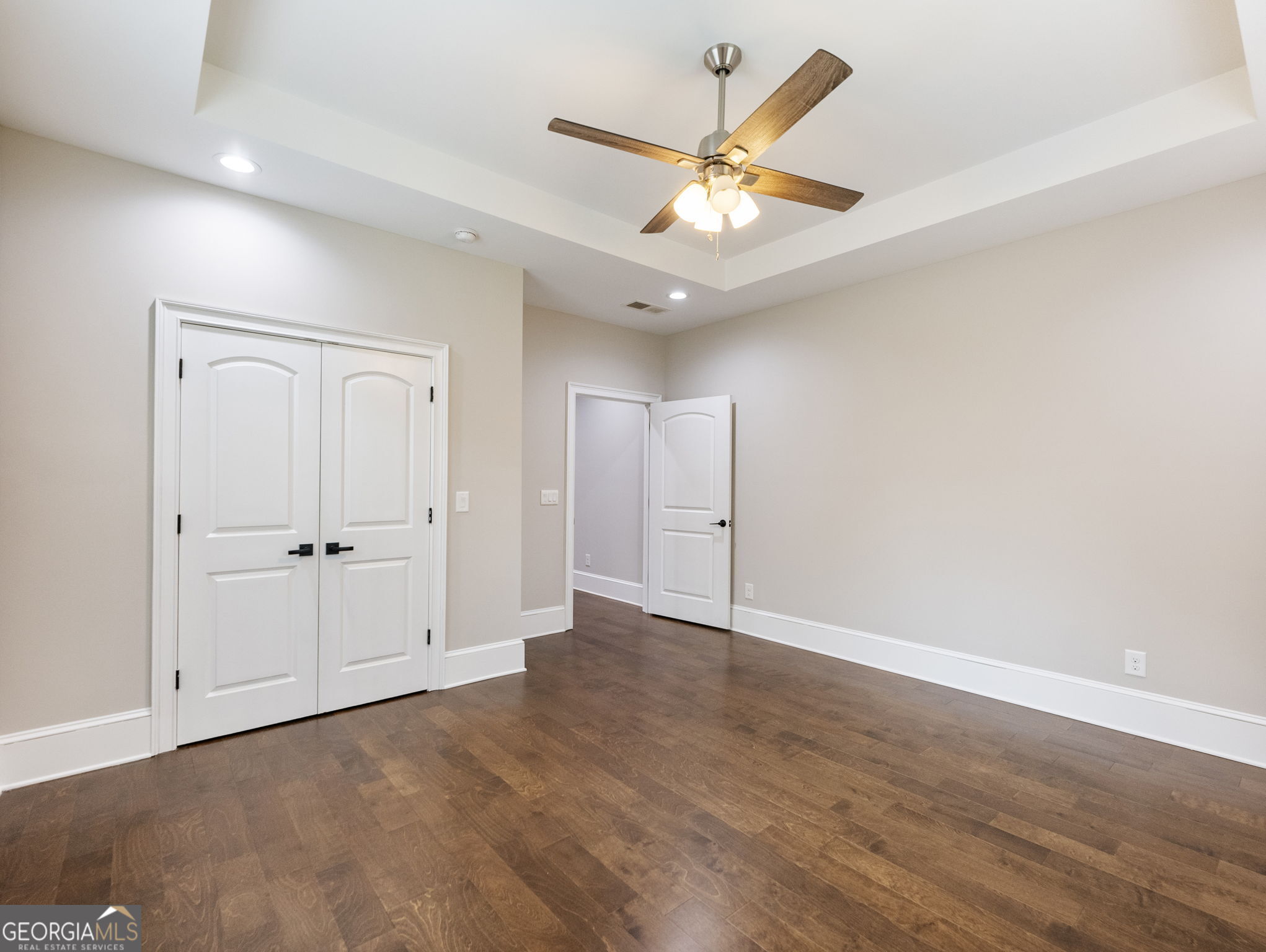 125 Iron Horse Trail Lula, GA 30554 - Photo 34 of 86 an empty room with wooden floor and ceiling fan