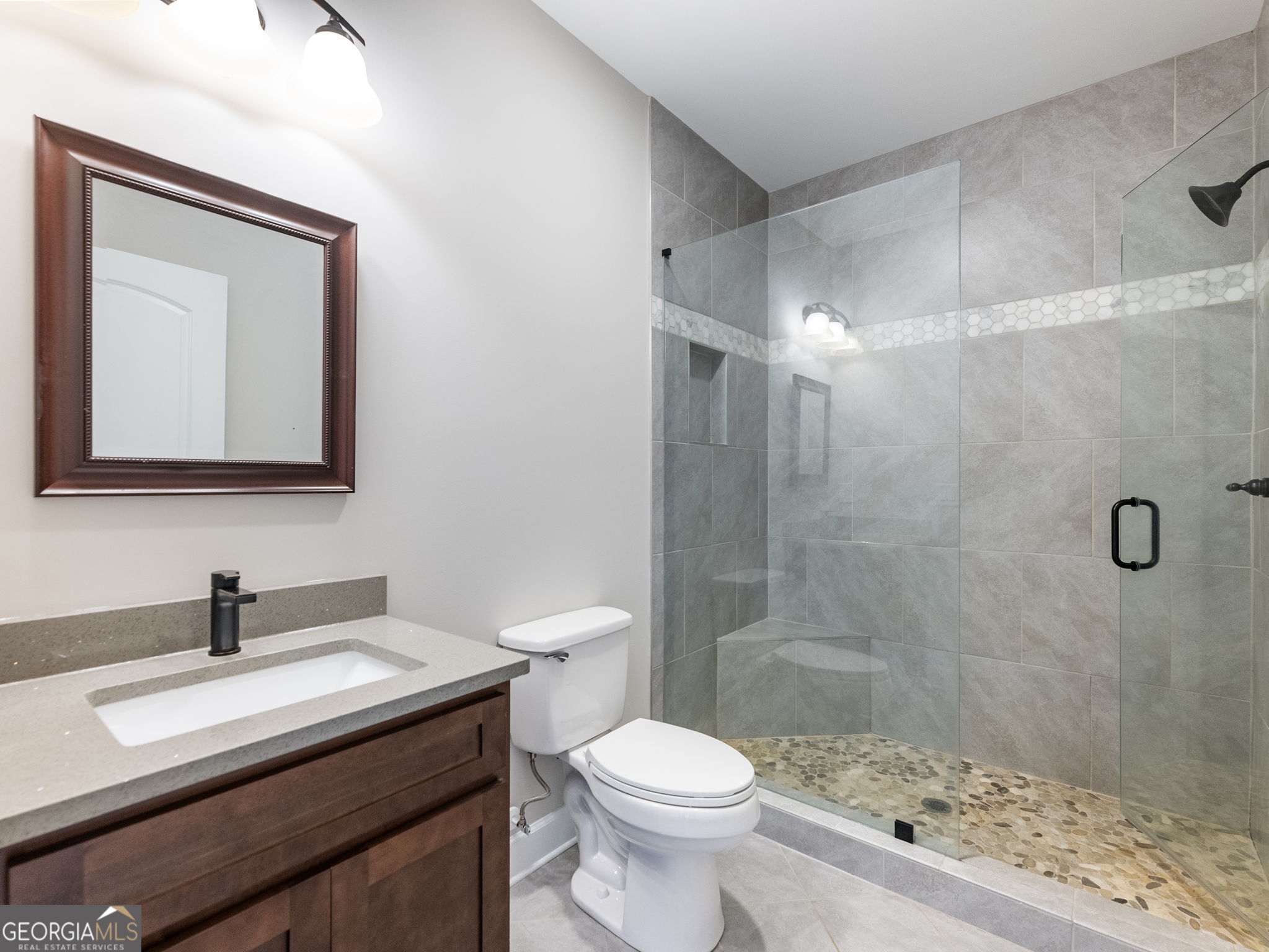125 Iron Horse Trail Lula, GA 30554 - Photo 37 of 86 a bathroom with a sink a toilet and shower