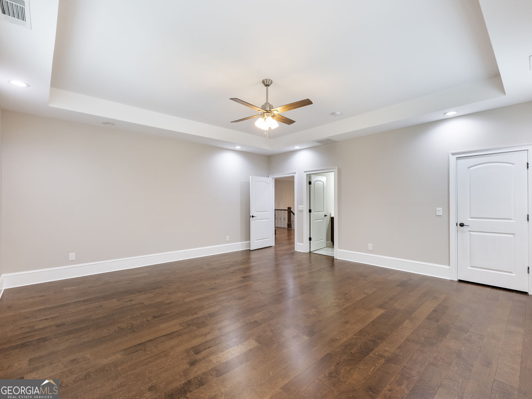125 Iron Horse Trail Lula, GA 30554 - Photo 40 of 86 a view of an empty room with chandelier fan and windows