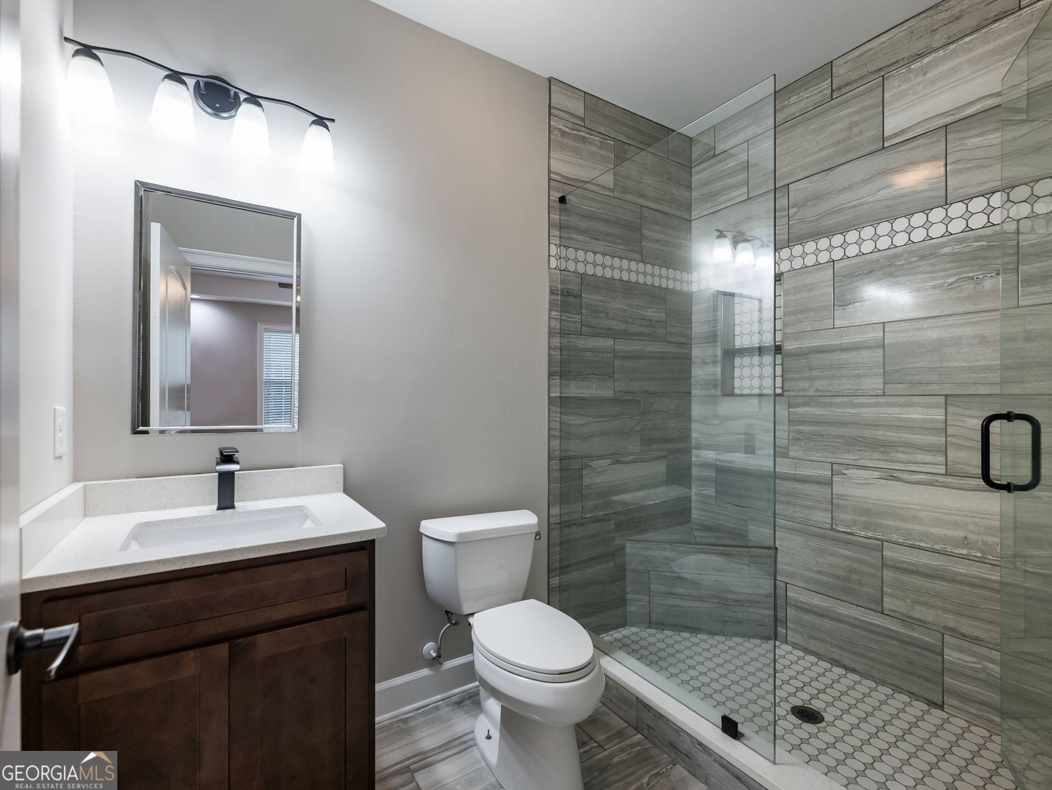 125 Iron Horse Trail Lula, GA 30554 - Photo 41 of 86 a bathroom with a shower a sink a toilet and mirror