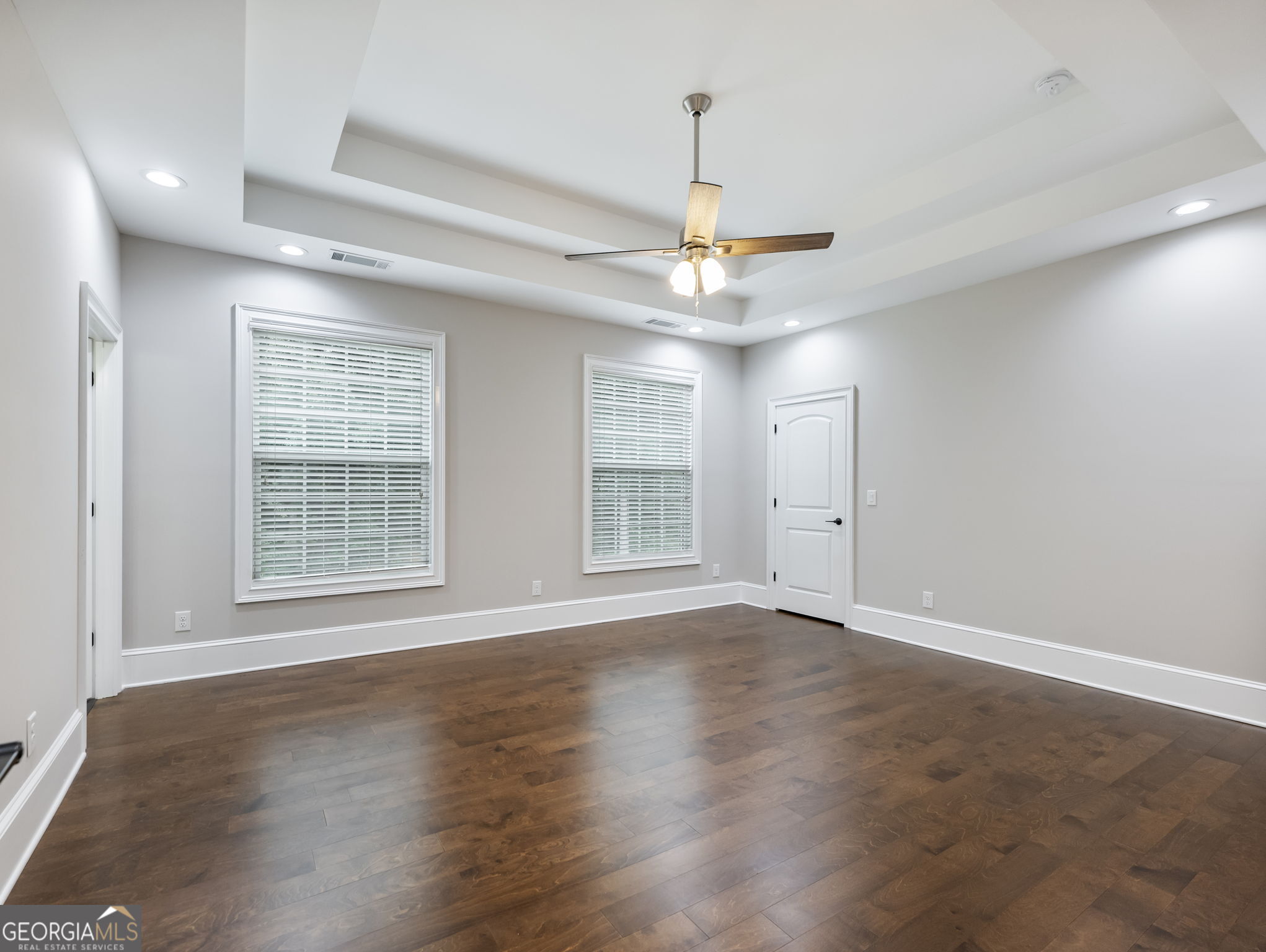 125 Iron Horse Trail Lula, GA 30554 - Photo 42 of 86 a view of an empty room with wooden floor and a window