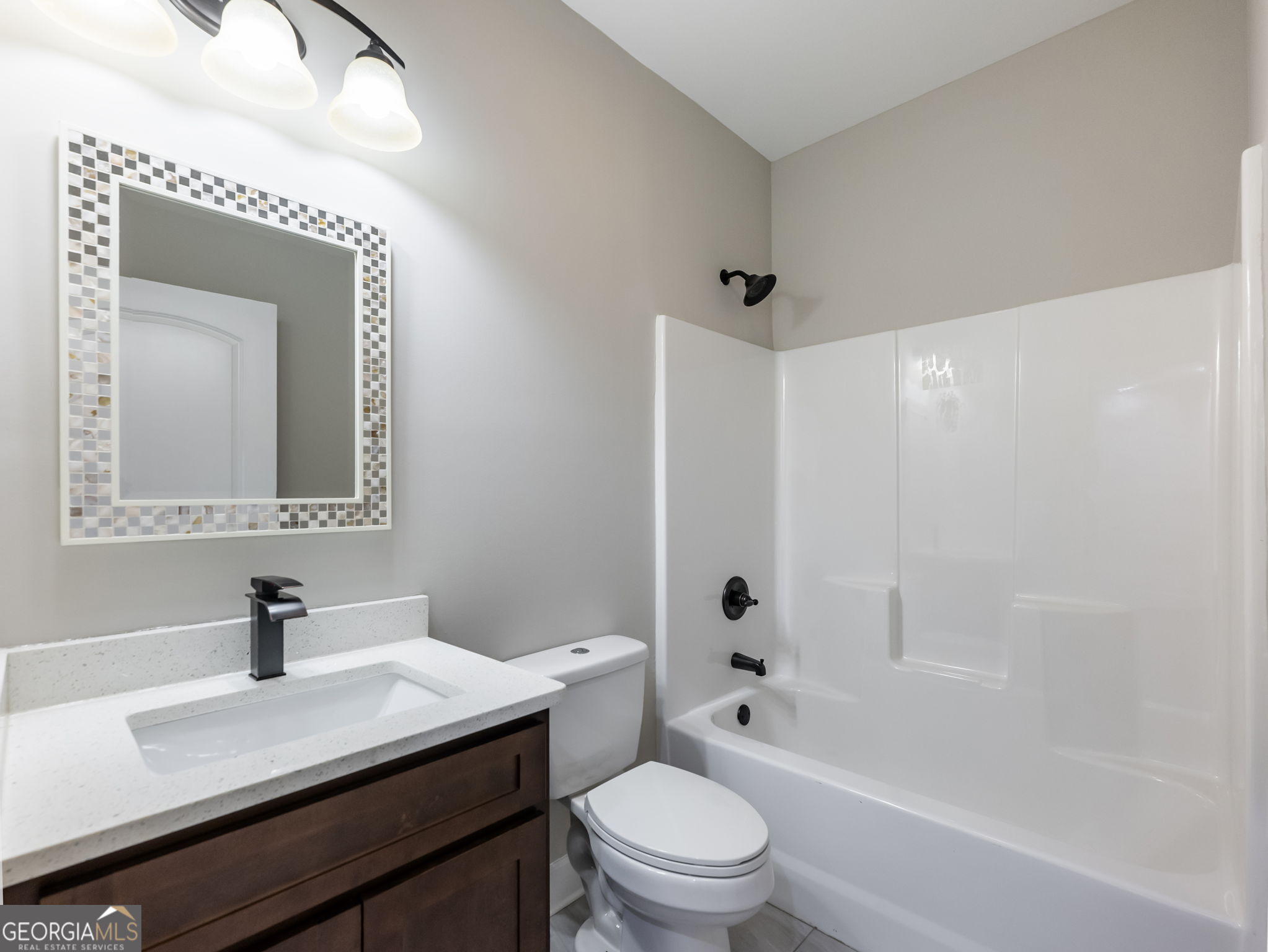 125 Iron Horse Trail Lula, GA 30554 - Photo 44 of 86 a bathroom with a bathtub a sink a toilet and mirror
