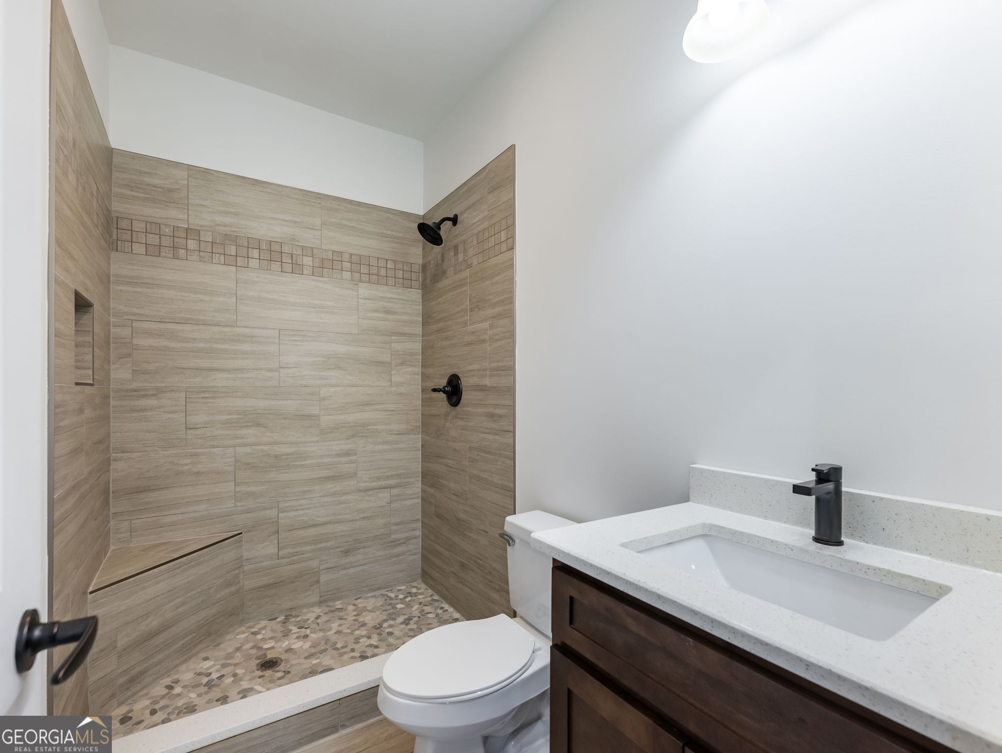 125 Iron Horse Trail Lula, GA 30554 - Photo 46 of 86 a bathroom with a sink a toilet and shower