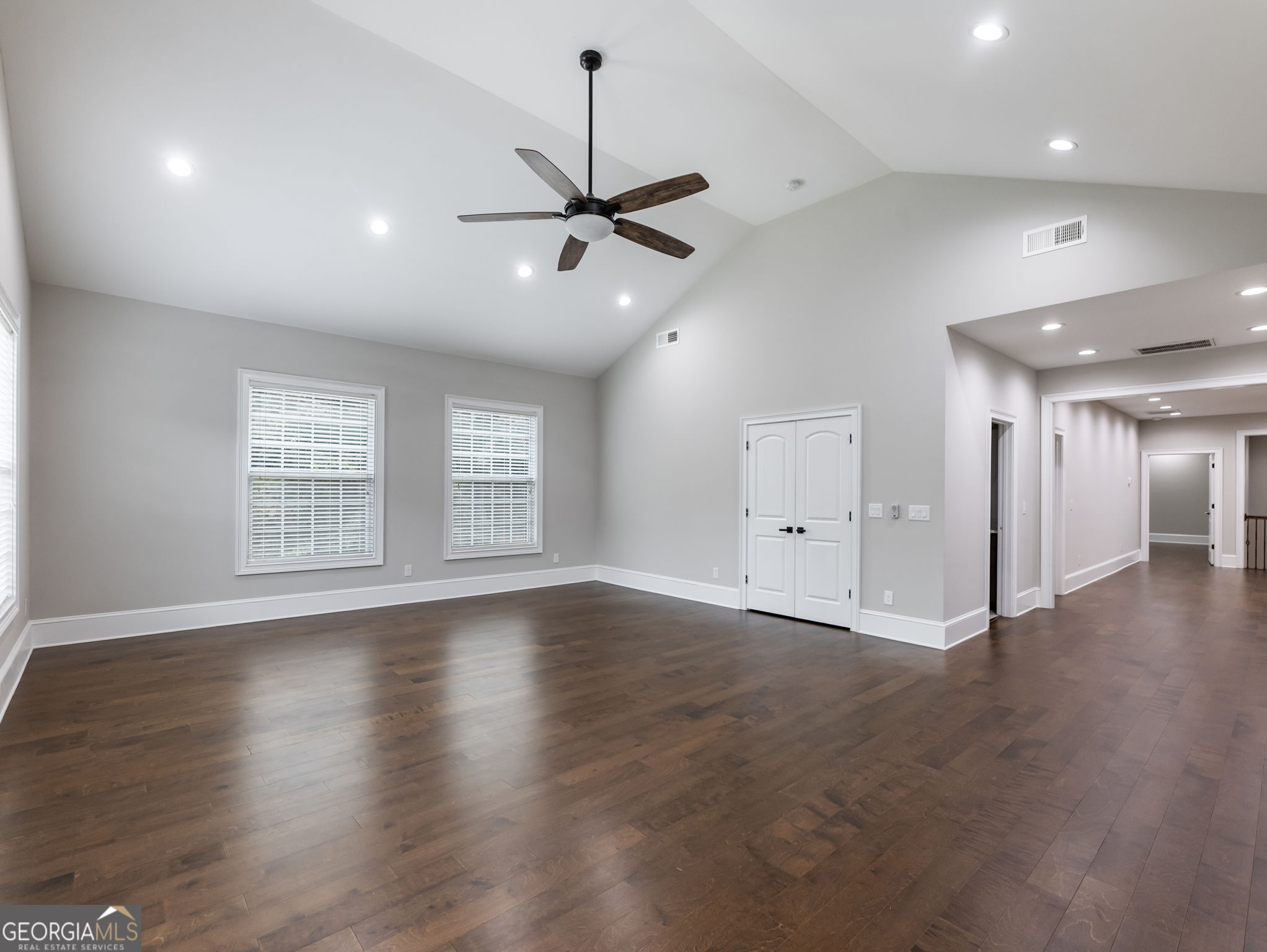 125 Iron Horse Trail Lula, GA 30554 - Photo 48 of 86 an empty room with wooden floor ceiling fan and windows