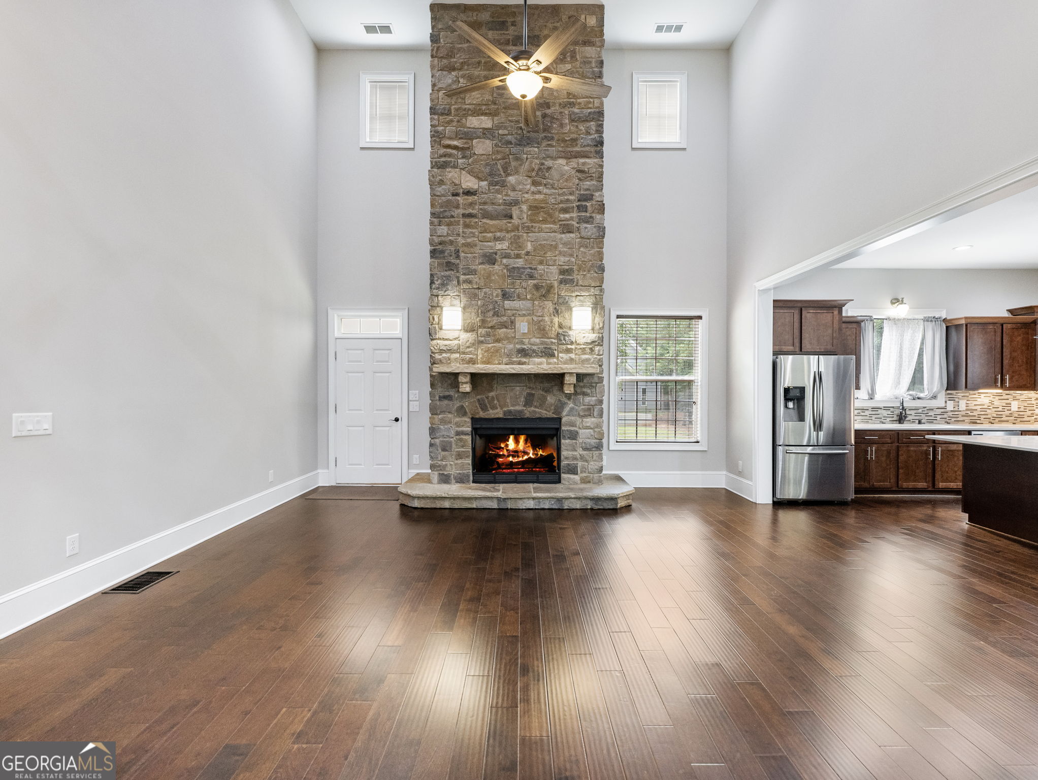 125 Iron Horse Trail Lula, GA 30554 - Photo 5 of 86 a view of a livingroom with wooden floor and a fireplace