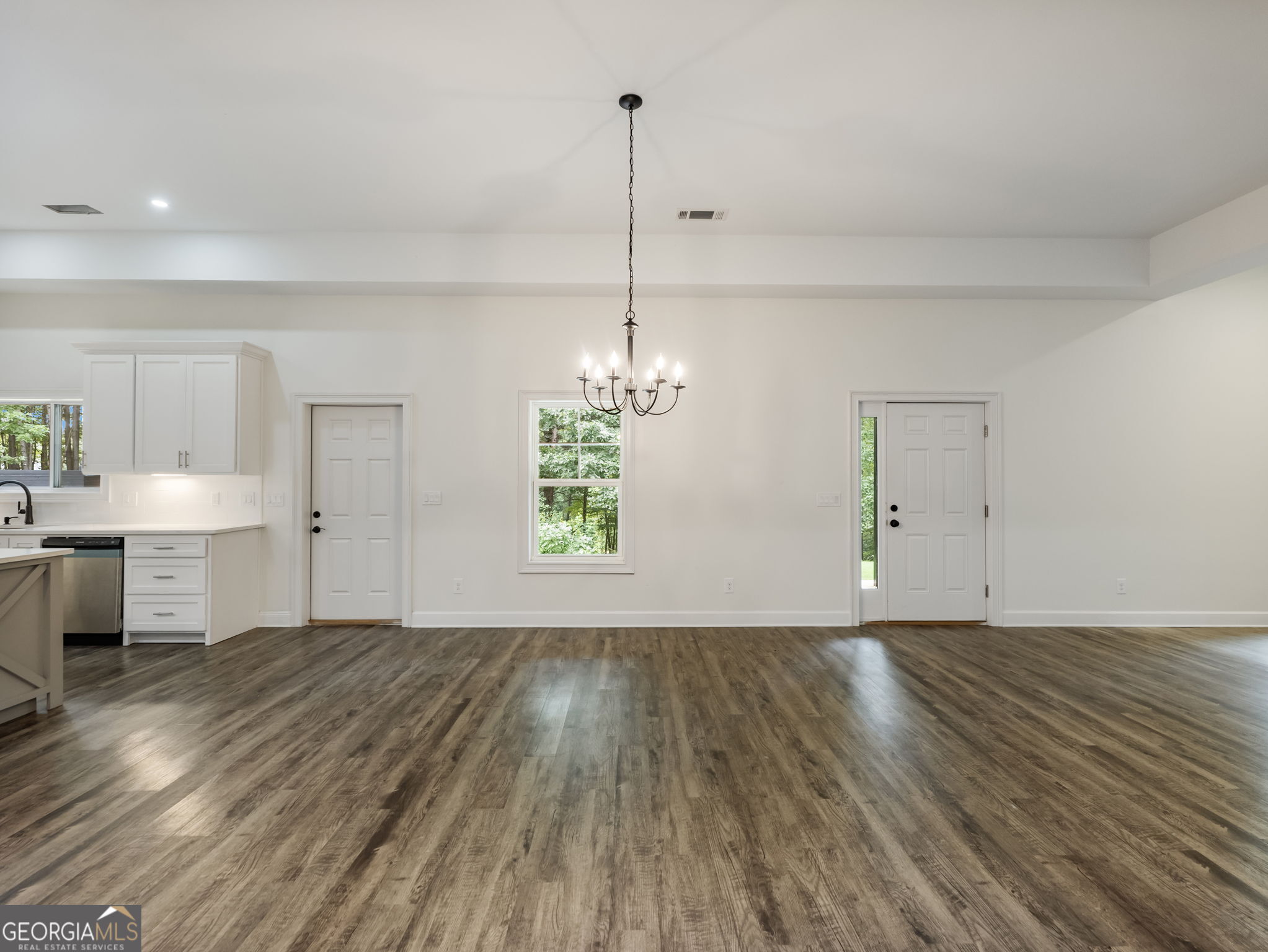 125 Iron Horse Trail Lula, GA 30554 - Photo 54 of 86 a view of a kitchen with a sink and dishwasher with wooden floor