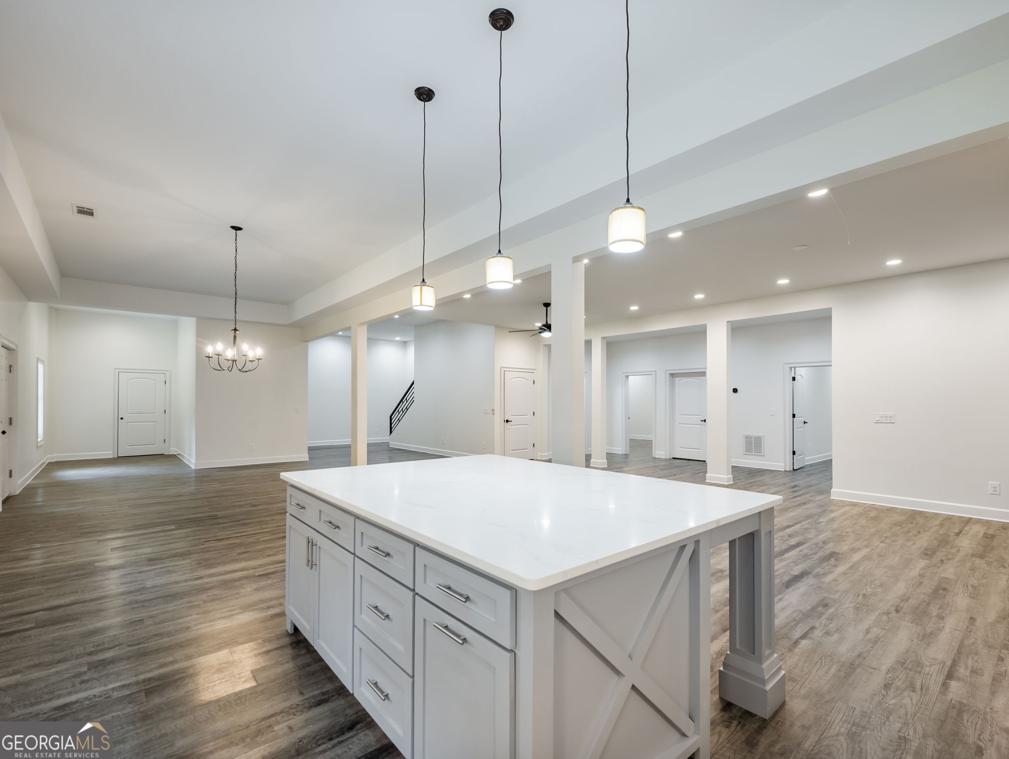 125 Iron Horse Trail Lula, GA 30554 - Photo 57 of 86 a large kitchen with kitchen island a stove a sink a center island and wooden floor