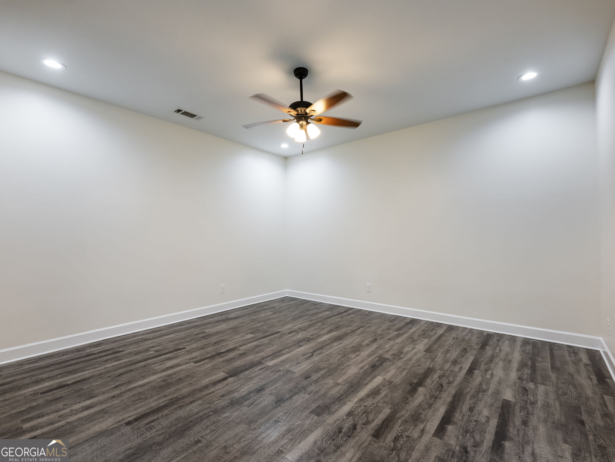 125 Iron Horse Trail Lula, GA 30554 - Photo 63 of 86 a view of an empty room with window and wooden floor
