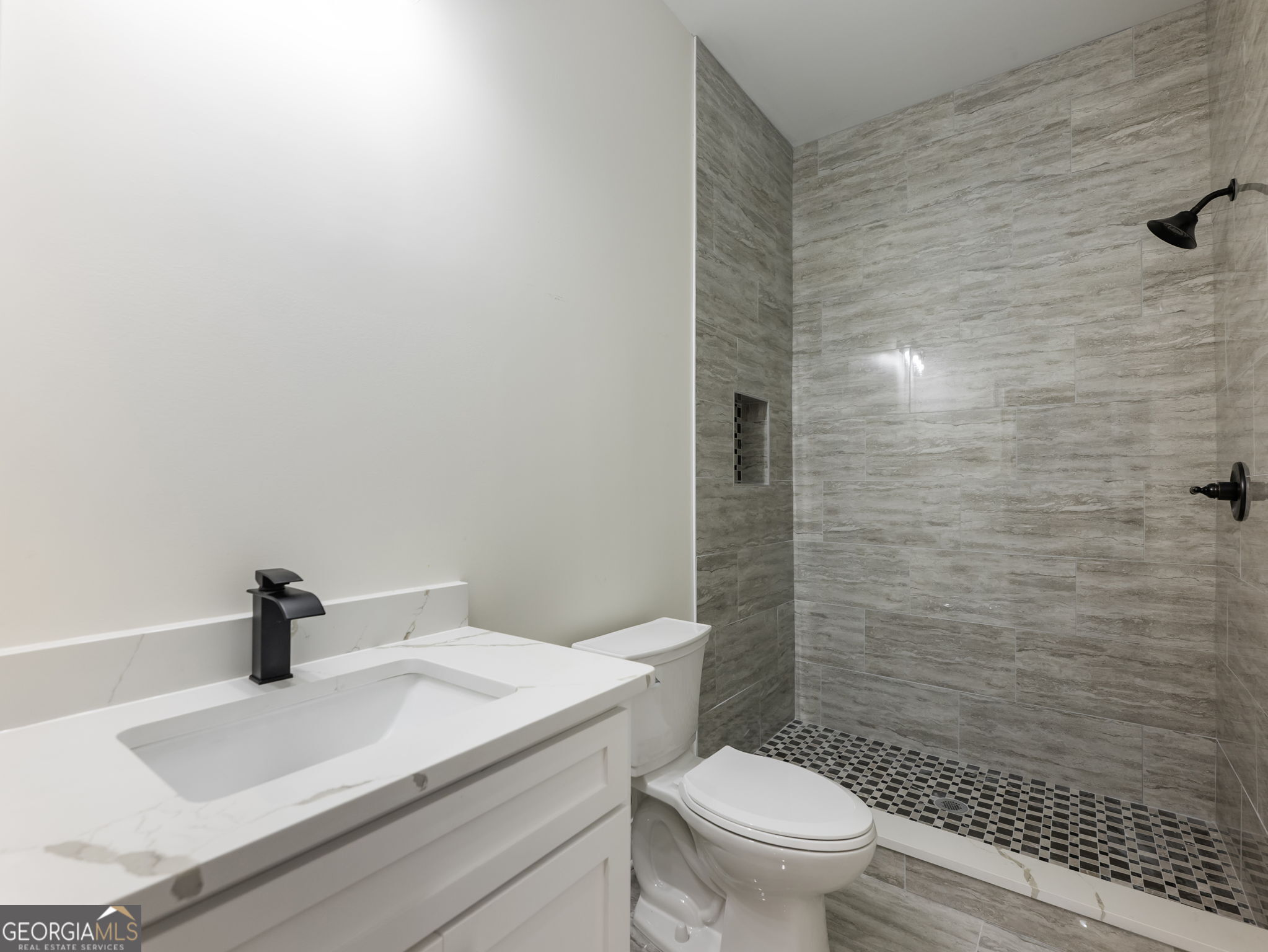 125 Iron Horse Trail Lula, GA 30554 - Photo 65 of 86 a bathroom with a sink a toilet and shower