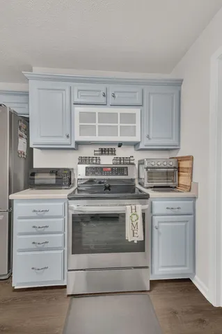 a kitchen with stainless steel appliances granite countertop a stove and a microwave oven