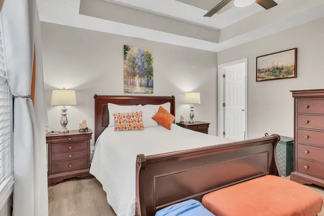 a bedroom with a bed and lamp on dresser