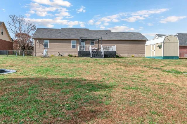 a view of a big house with a yard