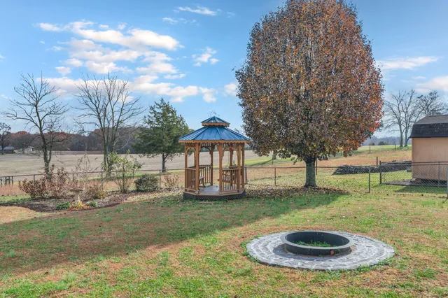 a view of a backyard with table and chairs