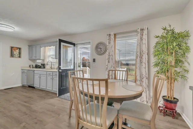 a view of a dining room with furniture and a potted plant