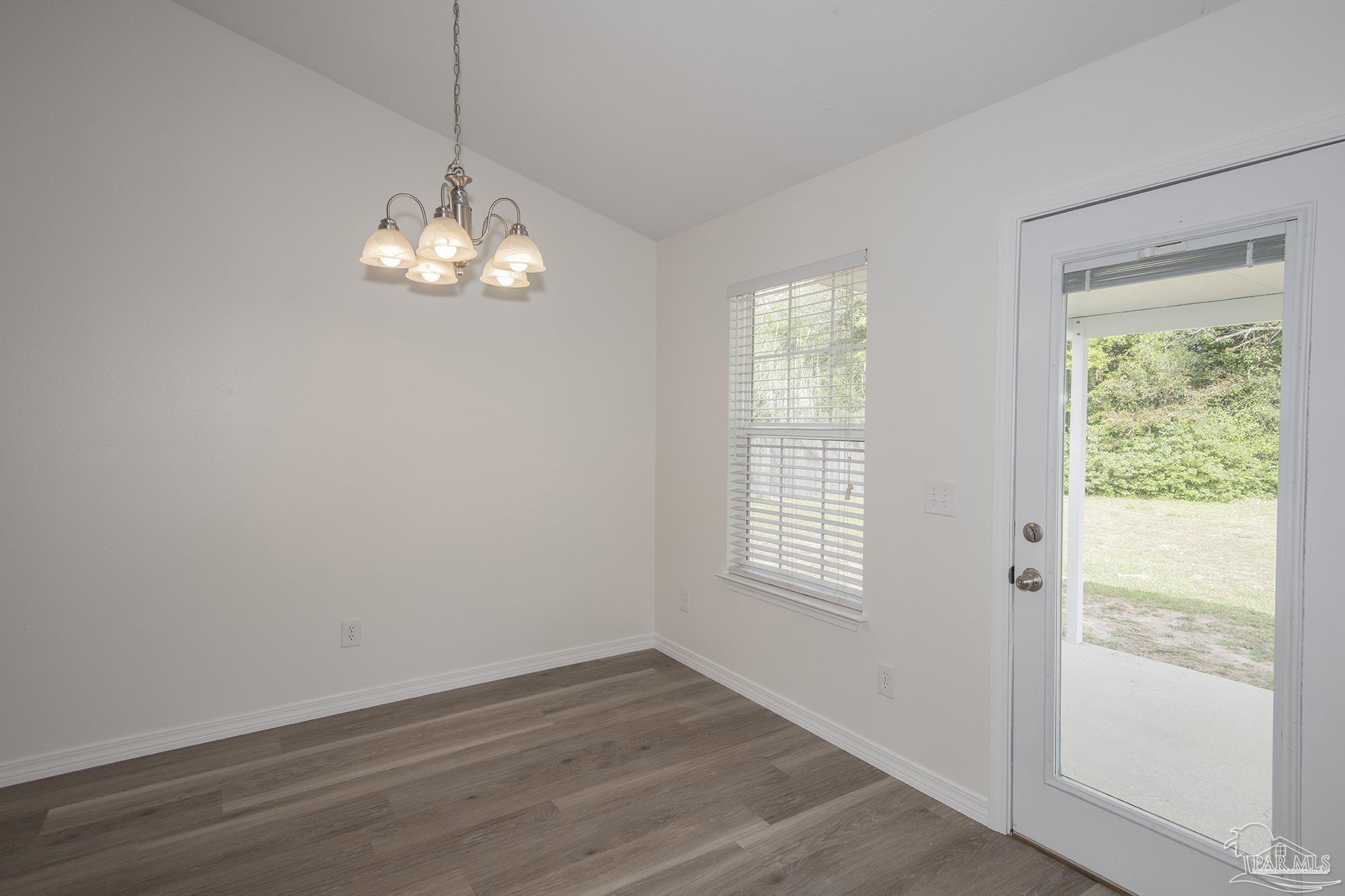 4608 Anna Simpson Road Milton, FL 32583 - Photo 2 of 4 an empty room with wooden floor and windows