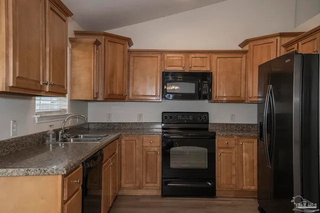 a kitchen with a sink stove and refrigerator