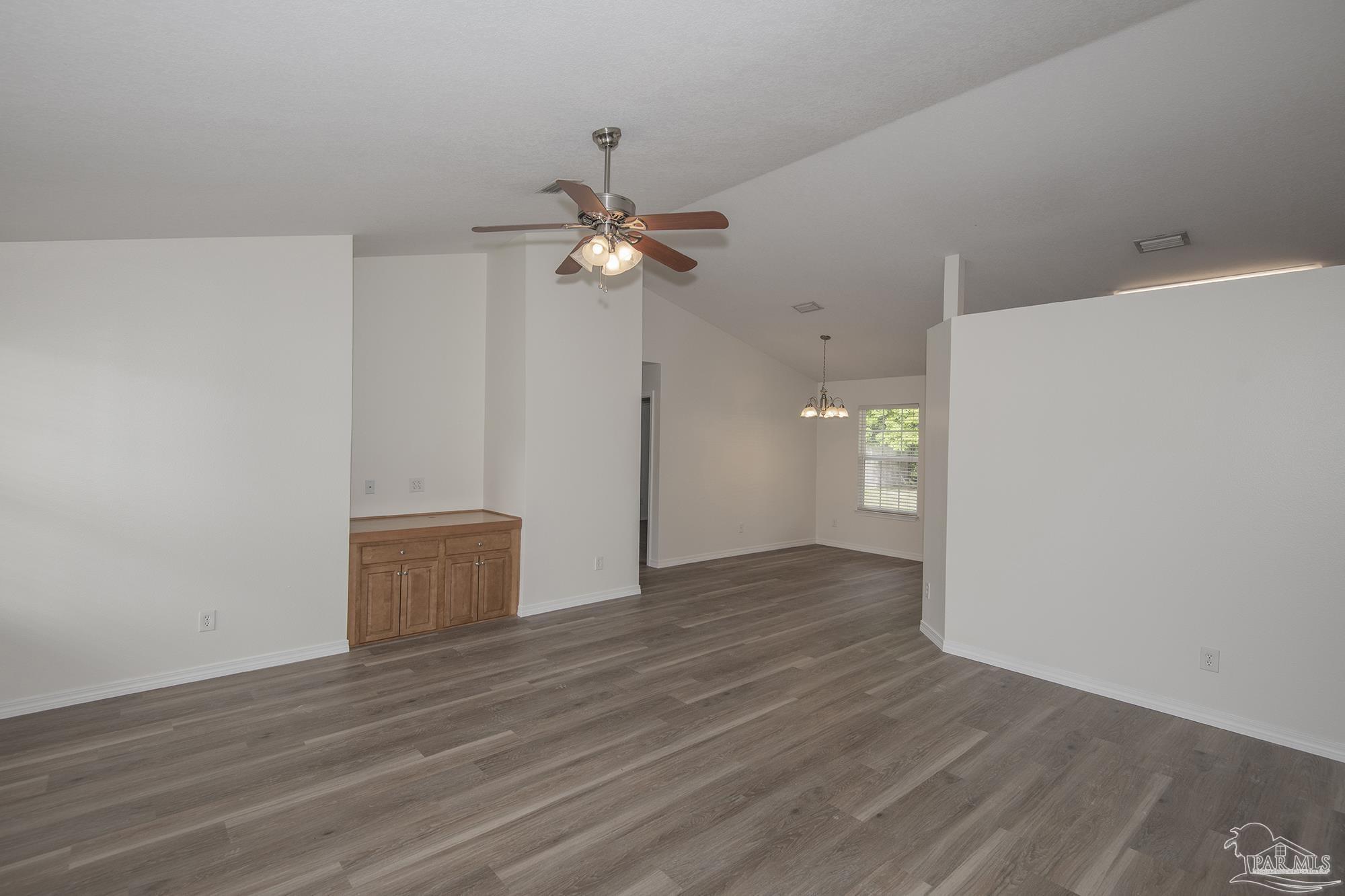 4608 Anna Simpson Road Milton, FL 32583 - Photo 4 of 4 a view of an empty room with wooden floor and a ceiling fan