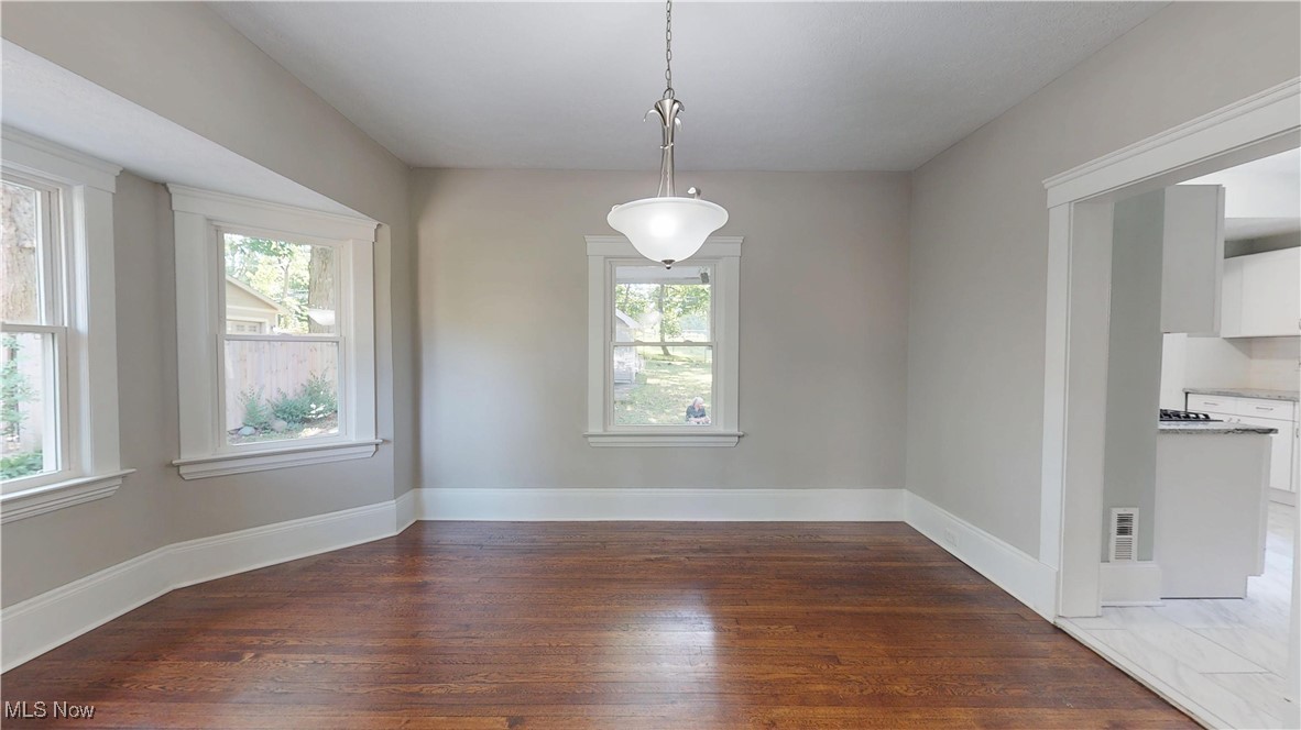 3174 Oak Road Cleveland, OH 44118 - Photo 8 of 33 Unfurnished dining area with wood finished floors and baseboards