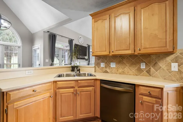 a kitchen with stainless steel appliances granite countertop a sink stove and cabinets