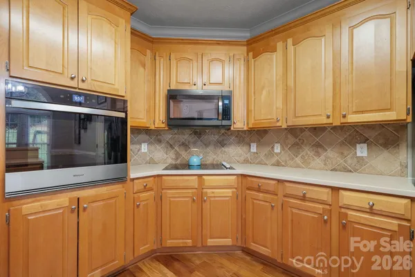 a kitchen with granite countertop cabinets stainless steel appliances and a sink