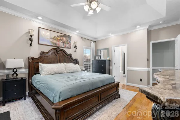 a bedroom with a bed and a chandelier