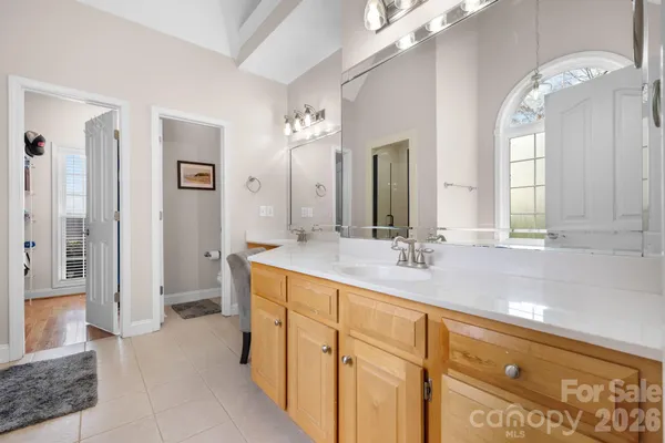 a bathroom with a double vanity sink and a mirror