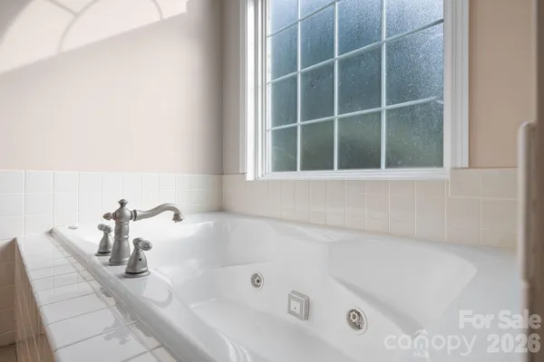 a bath tub sitting next to a window