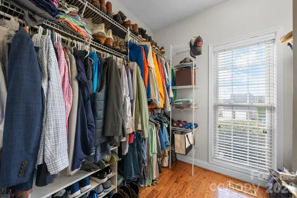 a view of walk in closet with clothes