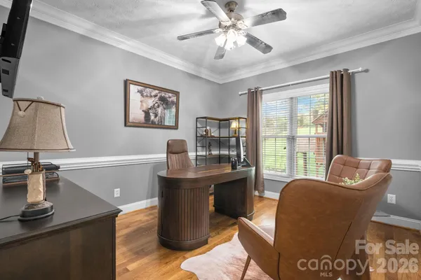 a living room with furniture a large window and a flat screen tv