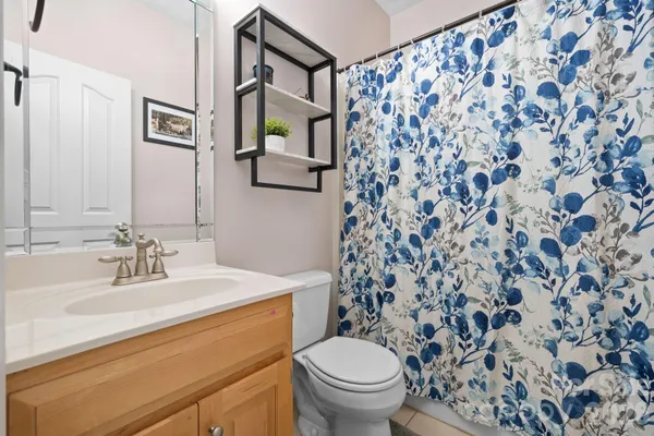 a bathroom with a sink toilet and mirror
