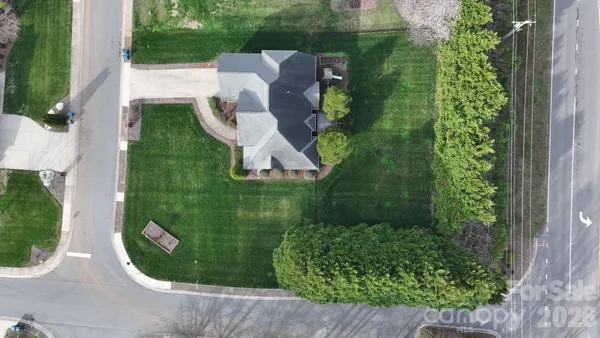 an aerial view of a house with a yard and outdoor seating