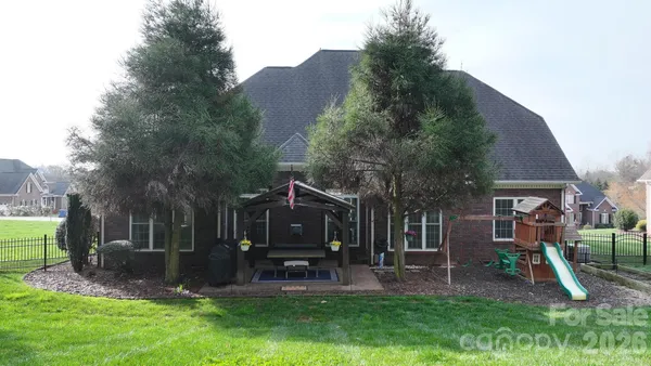 a front view of a house with a yard and table