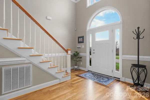 a view of entryway and hall with wooden floor