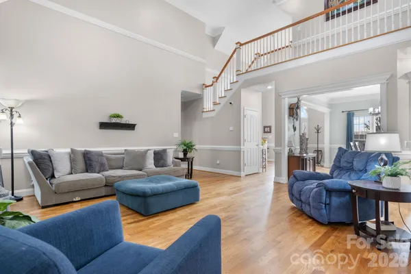 a living room with furniture and a dining table