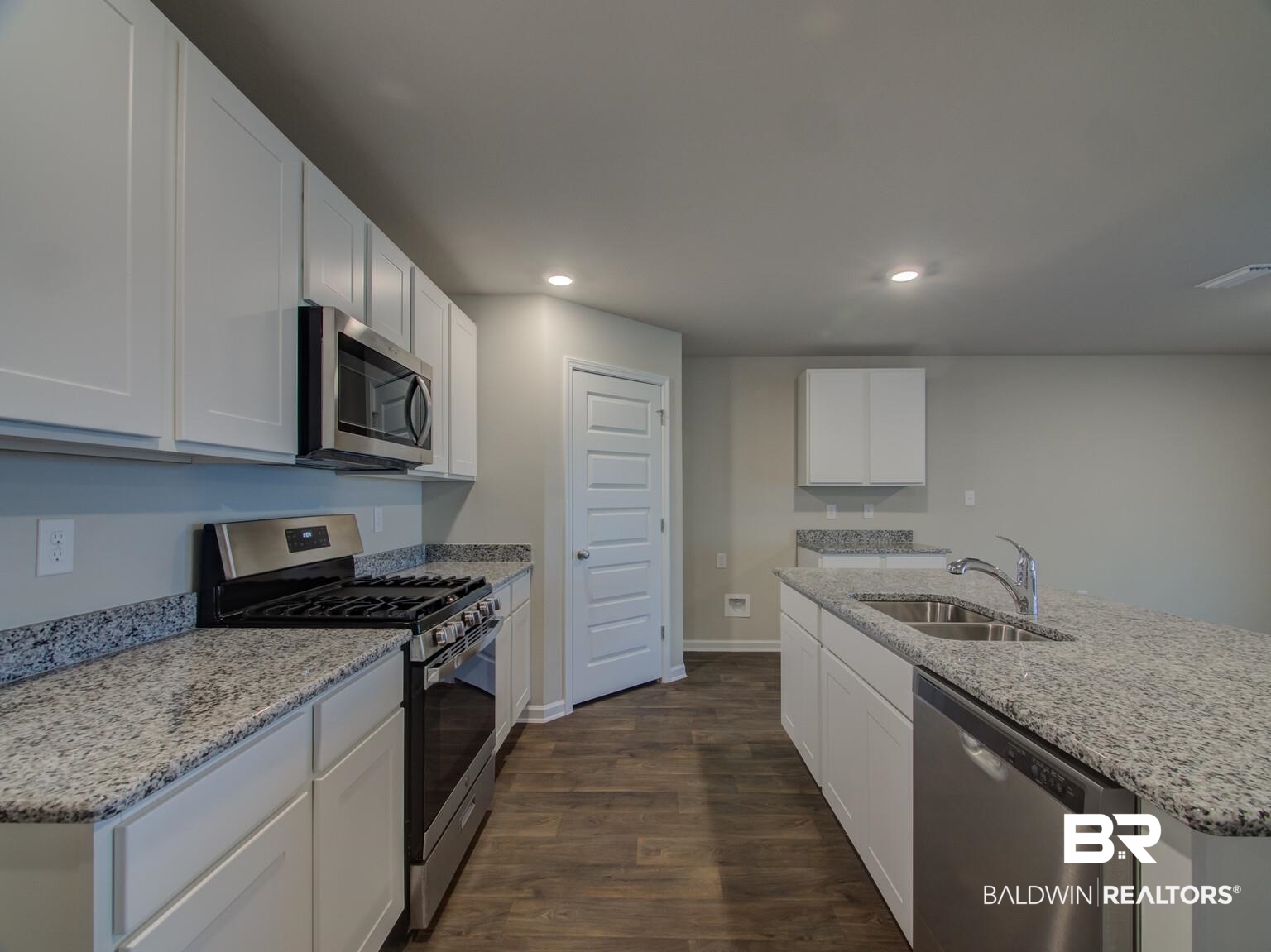 23952 Citation Loop Daphne, AL 36526 - Photo 15 of 69 Kitchen with stainless steel appliances, dark wood-type flooring, light stone countertops, white cabinets, and recessed lighting