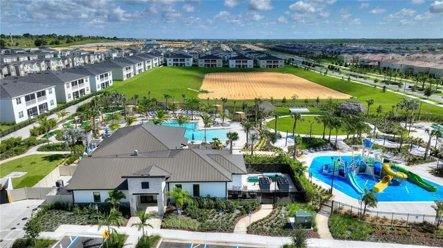 an aerial view of a house with a swimming pool patio and outdoor seating