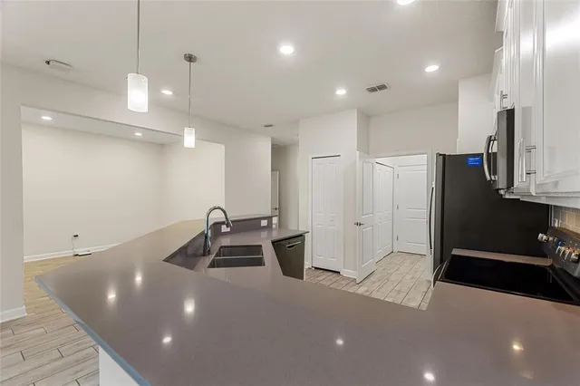a kitchen with a sink and refrigerator