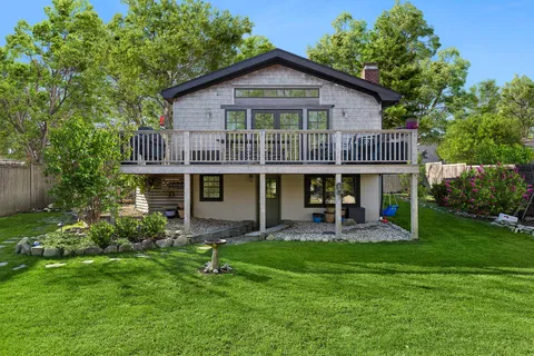 a front view of a house with garden and porch