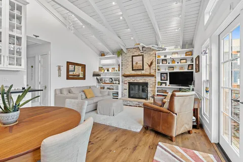 a living room with furniture a flat screen tv and a fireplace
