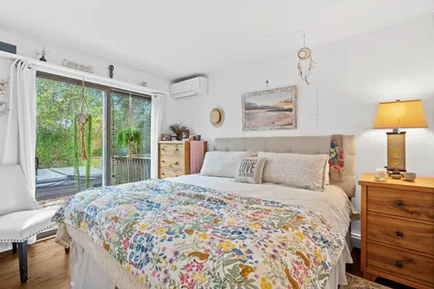 a bedroom with a bed and a lamp