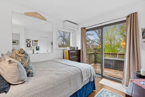 a bedroom with a large bed and a large window